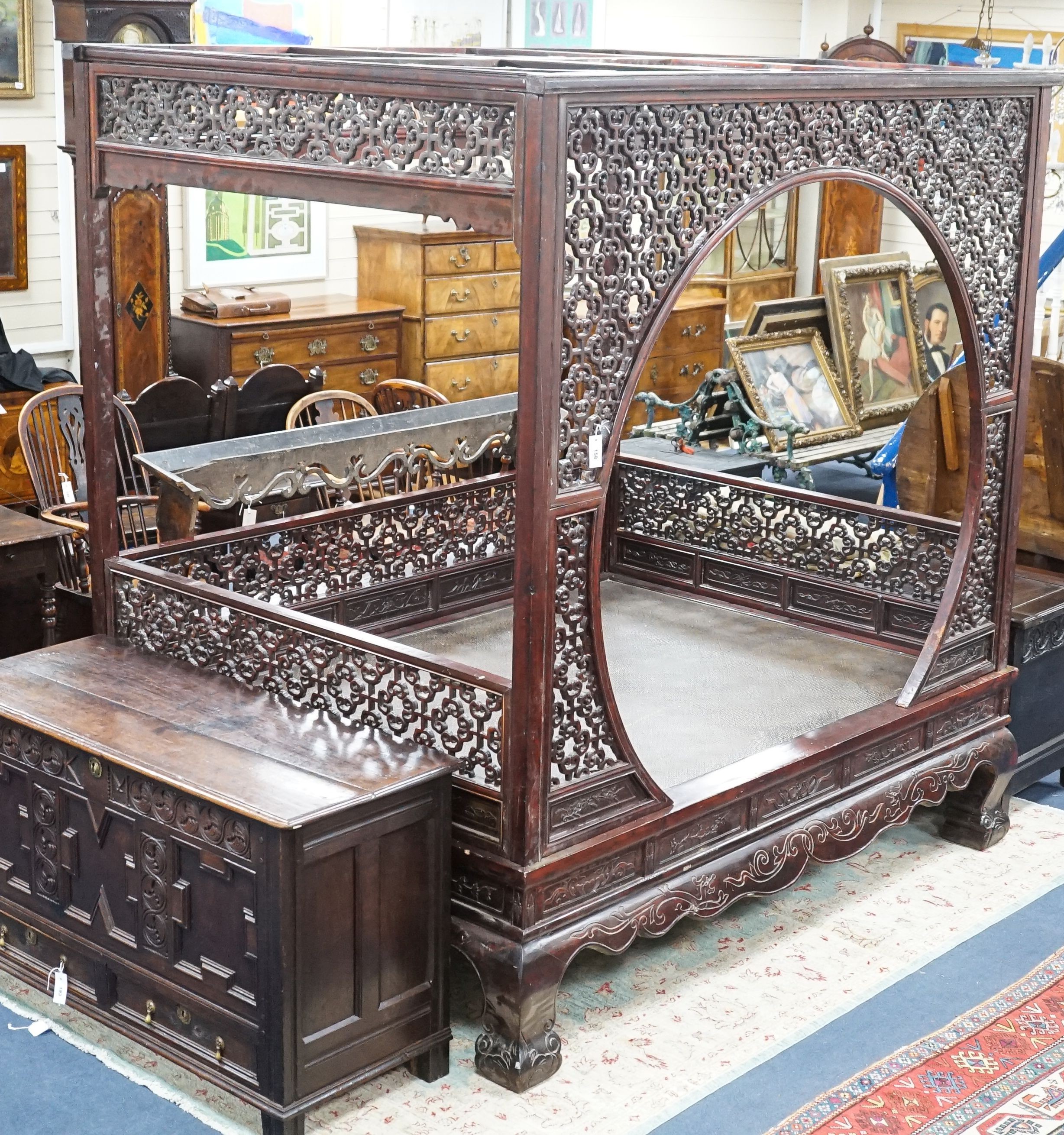 A Chinese carved elm opium bed, width 160cm, depth 207cm, height 225cm